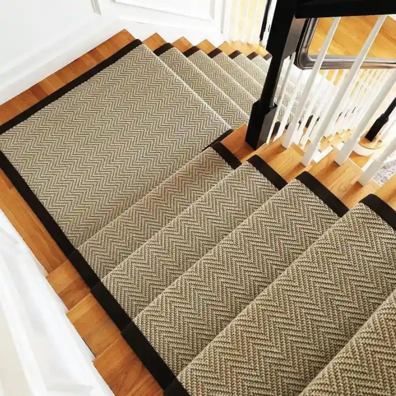A carpeted staircase with a runner and black borders in UAE